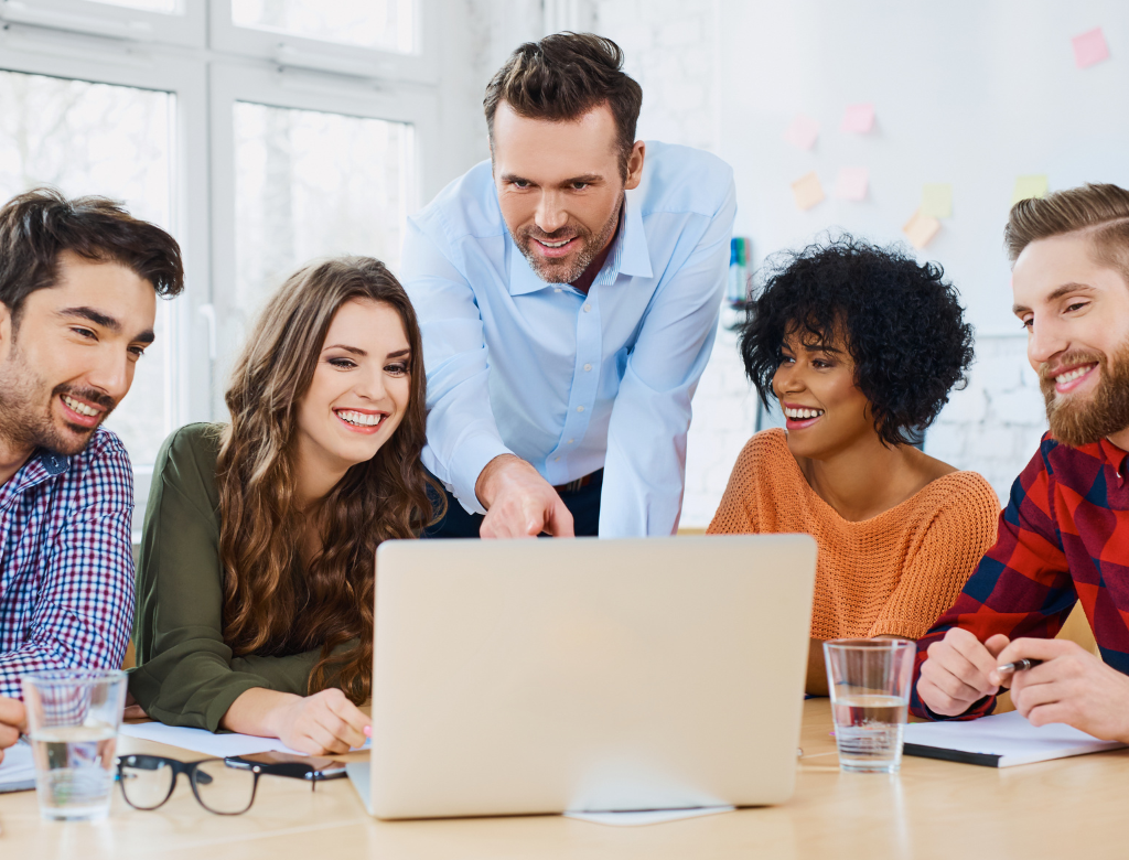 Creative agency coworkers discussing new project on laptop